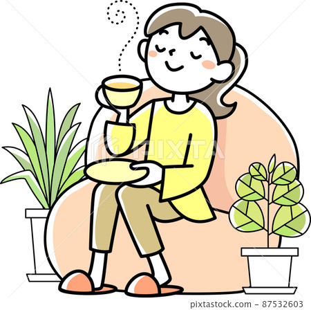 Young woman relaxing with a cup of tea 87532603