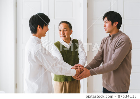 Shaking hands with father and son 87534113