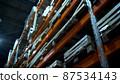 Rows of shelves with Goods in Cardboard Boxes and Packages full of in retail warehouse. Logistics, Sorting and Distribution Facility for Product Delivery. 87534143