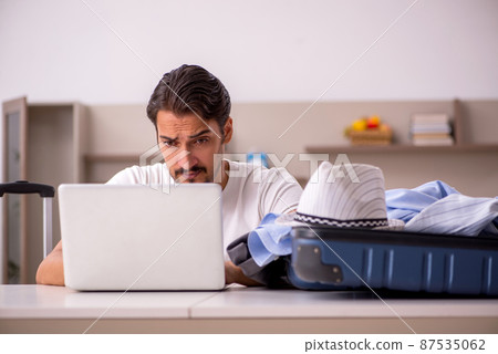 Young man preparing for trip at home 87535062