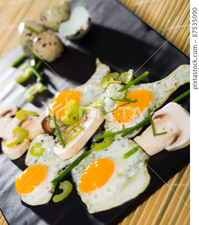 Broken fried quail eggs with mushrooms Broken fried quail eggs with mushrooms 87535090
