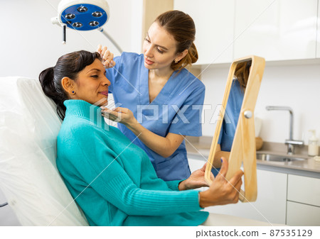 Woman having consultation at aesthetic medicine clinic Woman having consultation at aesthetic medicine clinic 87535129