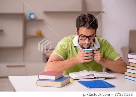 Young male student studying at home Young male student studying at home 87535156