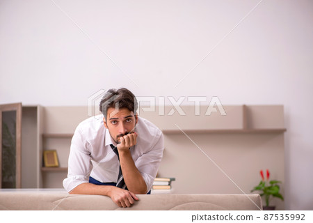 Young male employee working from home during pandemic 87535992
