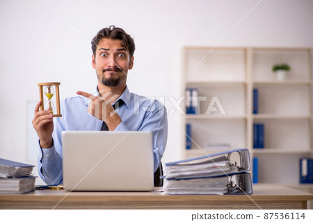 Young male employee in time management concept 87536114