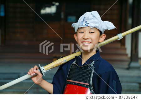 A boy enjoying kendo and doing his best A boy enjoying kendo and doing his best 87538147