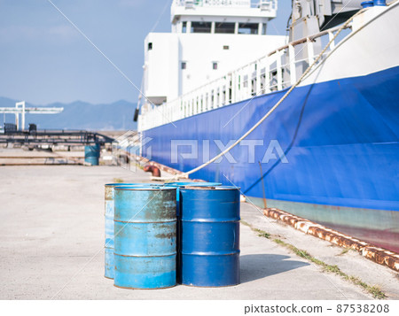 Drums placed to refuel a moored cargo ship Drums placed to refuel a moored cargo ship 87538208