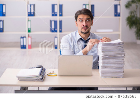 Young businessman employee unhappy with excessive work in the of 87538563
