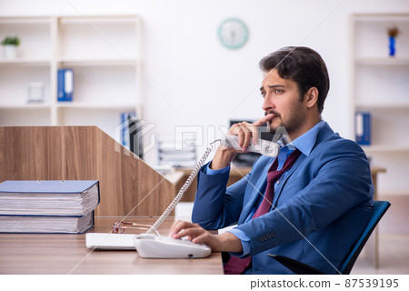Young male employee working in the office 87539195