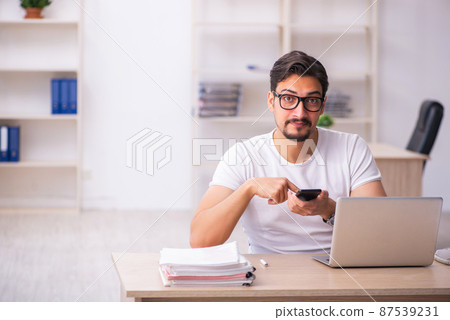 Young male student employee at workplace Young male student employee at workplace 87539231