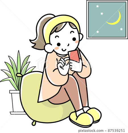 A young woman who stays up late looking at her smartphone 87539251