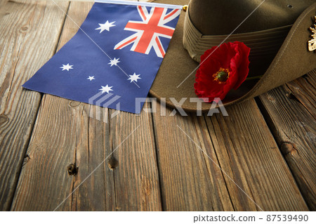 Anzac army slouch hat with Australian Flag and Poppy on wooden background Anzac army slouch hat with Australian Flag and Poppy on wooden background 87539490