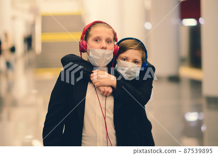 Children with face mask going back to school after covid-19 quarantine and lockdown. 87539895