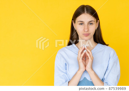 Evil plan. Sarcastic woman. Ironic expression. Pretty mockery lady in shirt holding hands in malicious joy isolated yellow copy space. 87539989