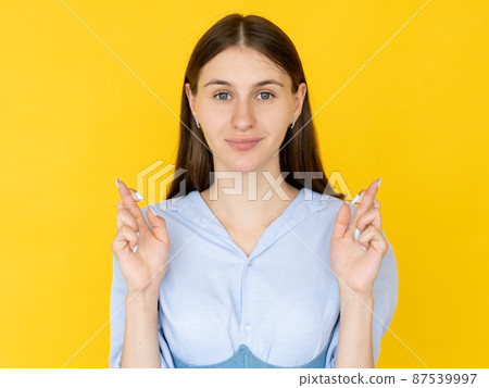 Good luck. Praying woman. Hopeful believes. Pretty inspired faithful lady crossing fingers asking wish come truth isolated yellow. Good luck. Praying woman. Hopeful believes. Pretty inspired faithful lady crossing fingers asking wish come truth isolated yellow. 87539997