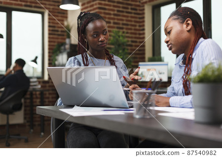 Research and development company office employees reviewing financial report. Research and development company office employees reviewing financial report. 87540982
