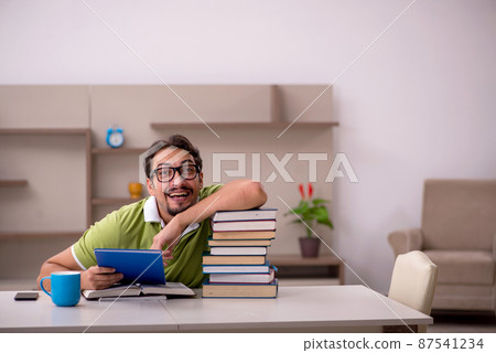 Young male student studying at home 87541234