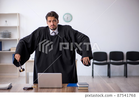 Young male judge working in the courthouse 87541768