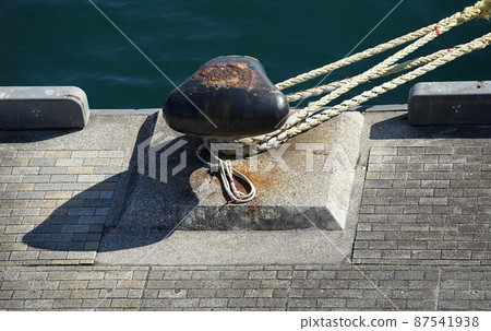 Rope for mooring vessels on the quay of the harbor 87541938