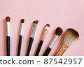 Makeup brush on pink background 87542957