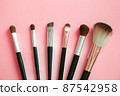 Makeup brush on pink background 87542958