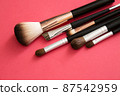 Makeup brush on red background 87542959