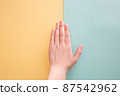 Hands on yellow and blue background 87542962
