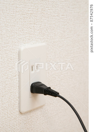 Outlet with a cord stuck in it Outlet with a cord stuck in it 87542976