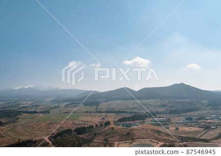 View of Volcanic Cone mountain from Saebyeol Oreum at winter in Jeju island, Korea View of Volcanic Cone mountain from Saebyeol Oreum at winter in Jeju island, Korea 87546945