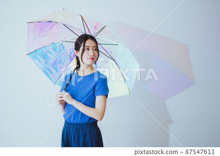 A woman holding an umbrella 87547611