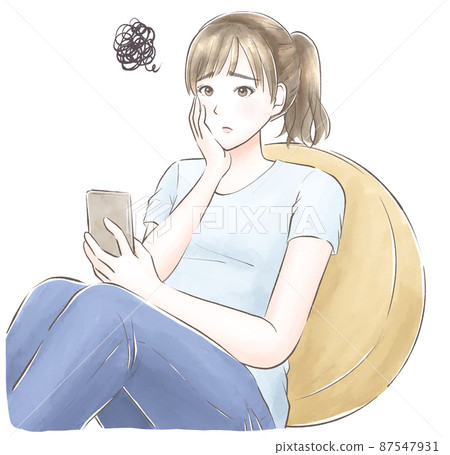 A woman who leans against a cushion, wears a cheek stick, and is worried about looking at a smartphone. 87547931