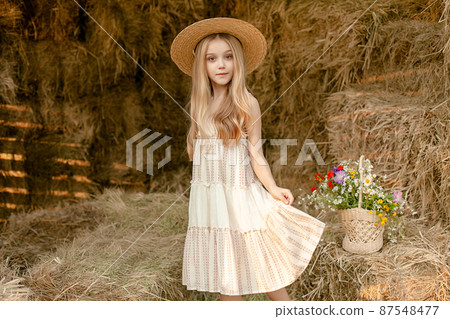 Tween girl enjoying summer vacation in countryside, posing on hayloft Tween girl enjoying summer vacation in countryside, posing on hayloft 87548477