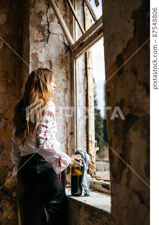 Molotov cocktail in the hands of a Ukrainian woman in embroidery Molotov cocktail in the hands of a Ukrainian woman in embroidery 87548806