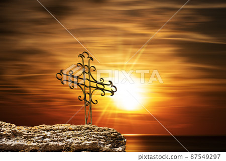 Wrought Iron Religious Cross Against a Beautiful Sunset over the Sea Wrought Iron Religious Cross Against a Beautiful Sunset over the Sea 87549297