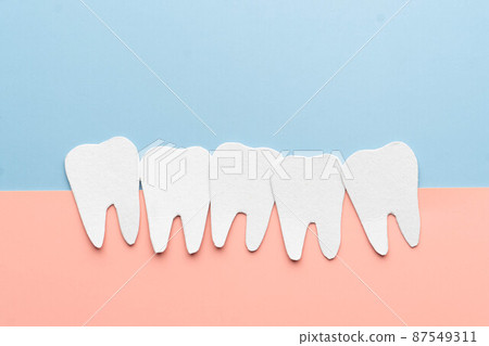 Crowding tooth cartoon made from paper. Problems resulting from dental crowding include gum disease, trouble chewing, toothache or jaw pain. Crowding tooth cartoon made from paper. Problems resulting from dental crowding include gum disease, trouble chewing, toothache or jaw pain. 87549311