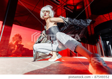 Stylish blonde on a red background. Stylish blonde on a red background. 87549352