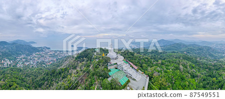 Front and right side of white buddha statute with panorama aerial view set on mountain in Thailand Front and right side of white buddha statute with panorama aerial view set on mountain in Thailand 87549551