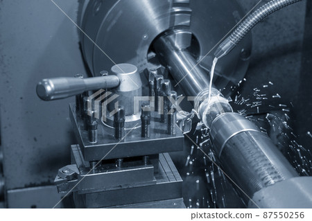 The lathe machine cutting  the metal  shaft parts with water base coolant method. 87550256