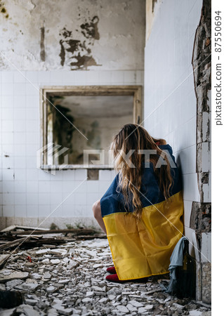 A Ukrainian woman in a ruined house. Flag of Ukraine. Stop War A Ukrainian woman in a ruined house. Flag of Ukraine. Stop War 87550694