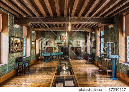 Anderlecht, Brussels - Belgium - Main living room and exposition hall with wooden floor and furniture and art objects at the Erasmus house Anderlecht, Brussels - Belgium - Main living room and exposition hall with wooden floor and furniture and art objects at the Erasmus house 87550837