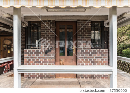 Auw An der Kyll, Rhineland-Palatinate - Germany - Facade of a small cottage style cafe along the Kyll valley railwaytrack 87550900