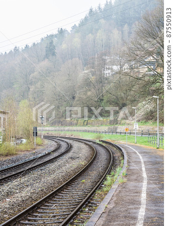 Kordel, Rhineland-Palatinate - Germany -Double bending railwaytrack in the foggy nature landscape along the Kyll creek valley 87550913