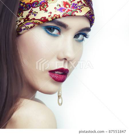 young pretty modern girl with bright shawl on head emotional posing isolated on white background, asian people ethnicity 87551847