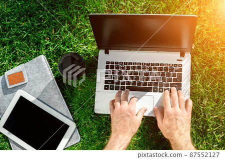 Close-up shot of handsome man's hands touching laptop computer's screen. 87552127