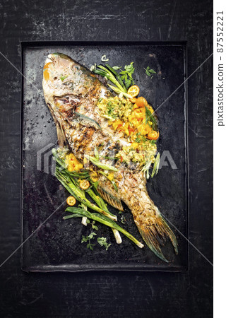 BBQ parrotfish with mango salsa as top view 87552221