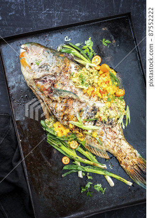 BBQ parrotfish with mango salsa as top view 87552222
