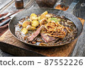 roast beef with fried onion rings and potato chips 87552226