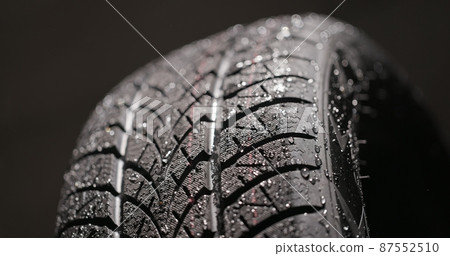 Clean car tires against dark background closeup 87552510