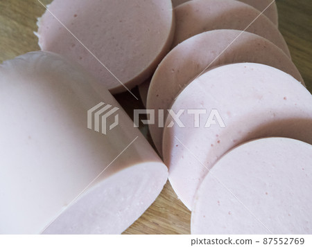 Boiled sausage cut into pieces, a close-up shot. Boiled sausage cut into pieces, a close-up shot. 87552769