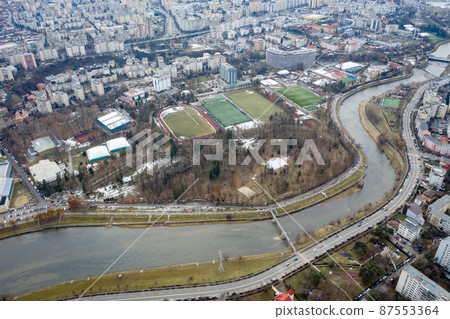 Aerial above view of river crossing the city 87553364